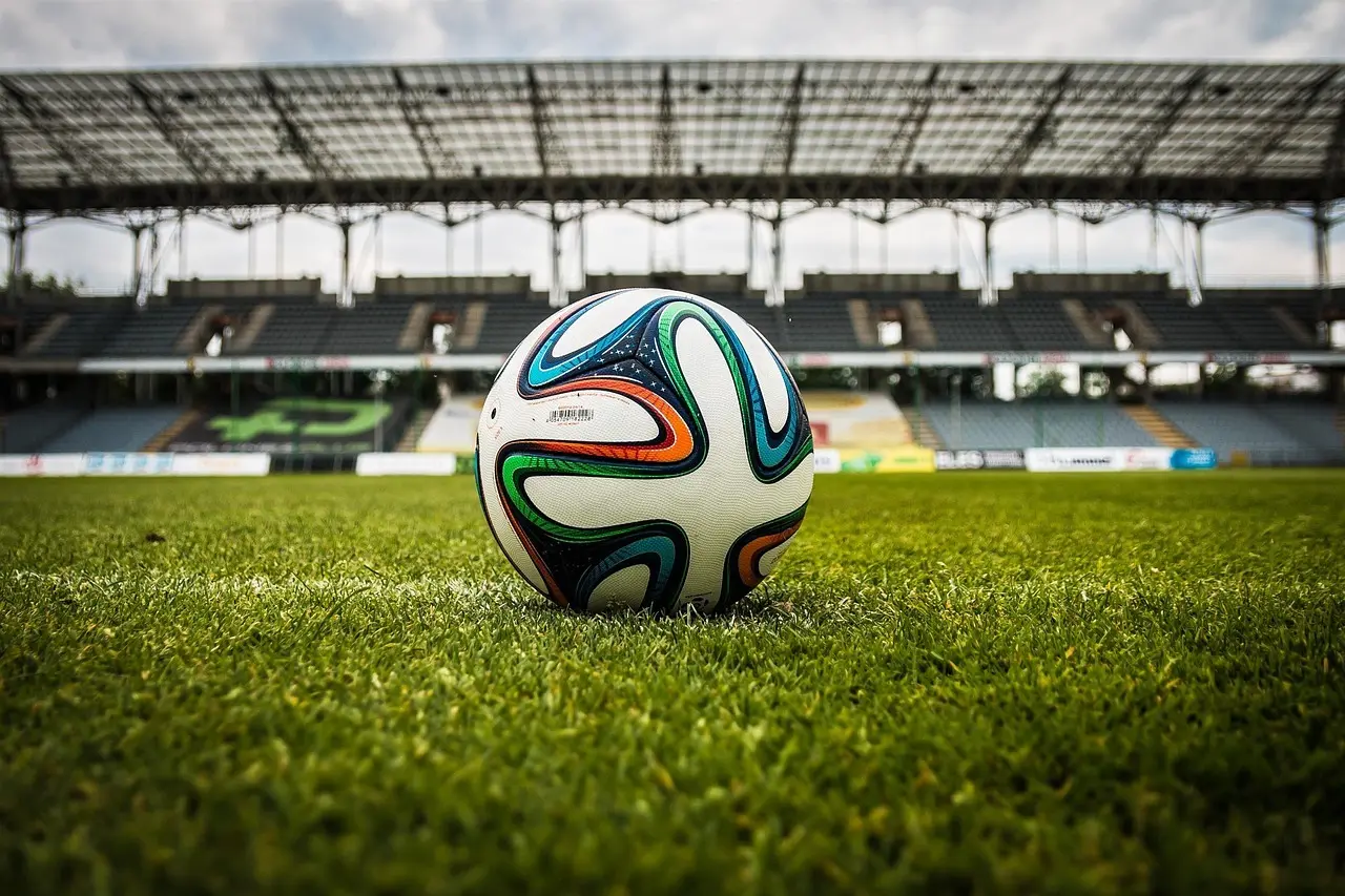 Fodbold på græs foran stadion